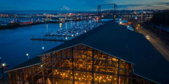 View of a boathouse in downtown Tacoma at dusk with Mt. Rainier in the distance