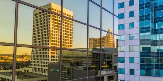 An image of the sunset reflected on the windows of an office building in Tacoma