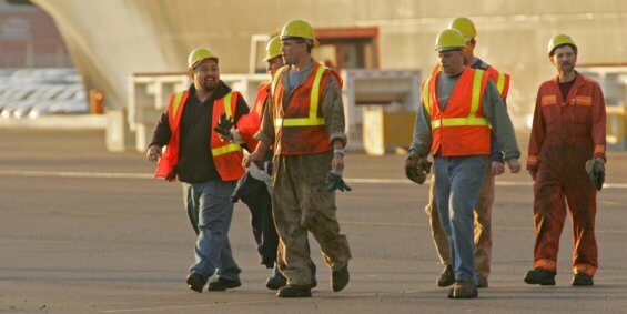 A group of male manufacturing employees walking in Tacoma